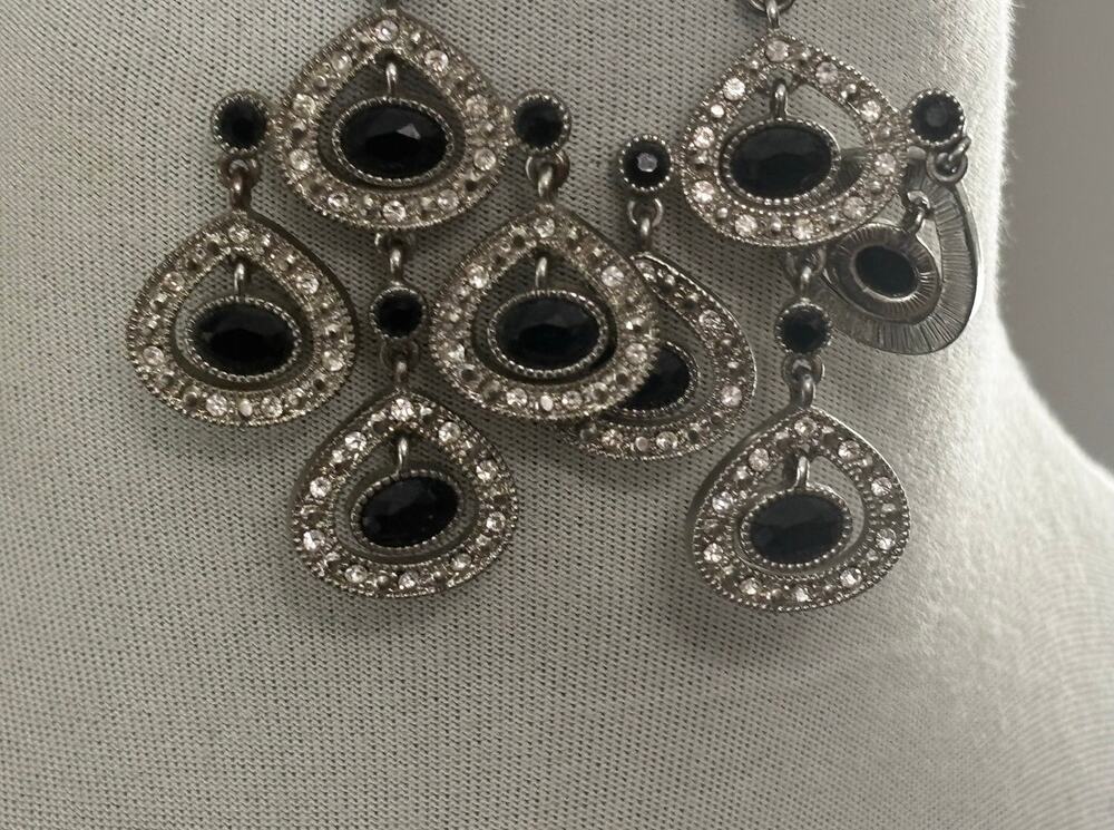 Chandelier earrings featuring casading teardrop design, black faceted stones